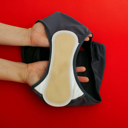 A panty with a white gusset with an attached snap-free, adhesive-free, reusable panty liner