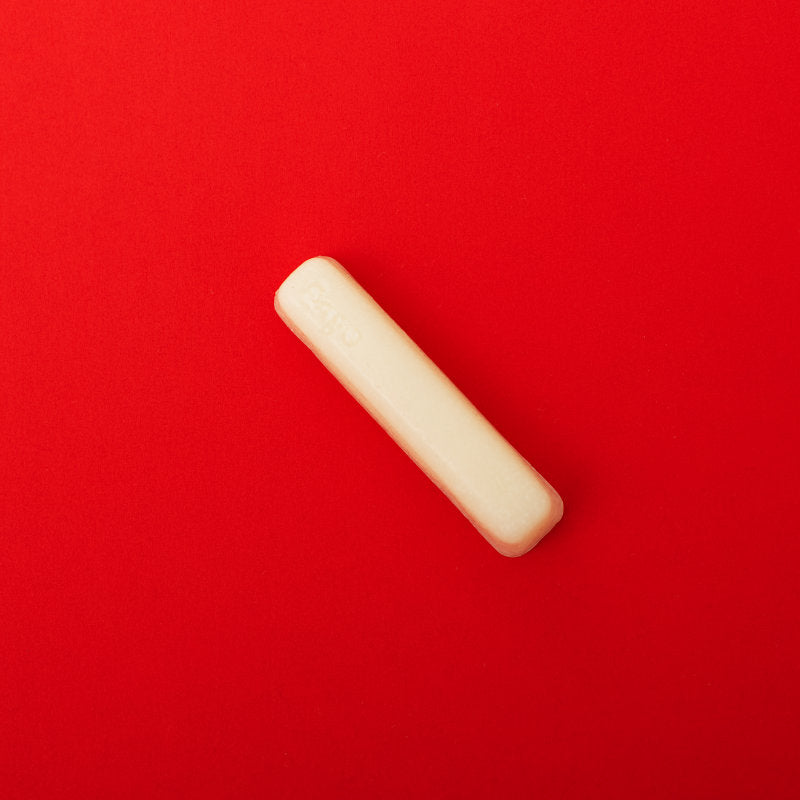 a white stain remover stick on a red background