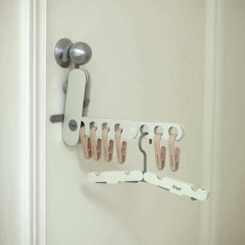 Foldable clothespin holder with clothing clips hooked onto to a door knob