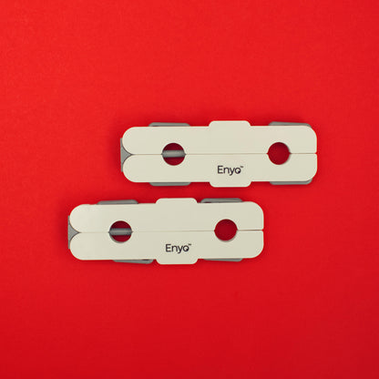 Two portable travel white and light grey plastic foldable hangers with 4 clips on a red background