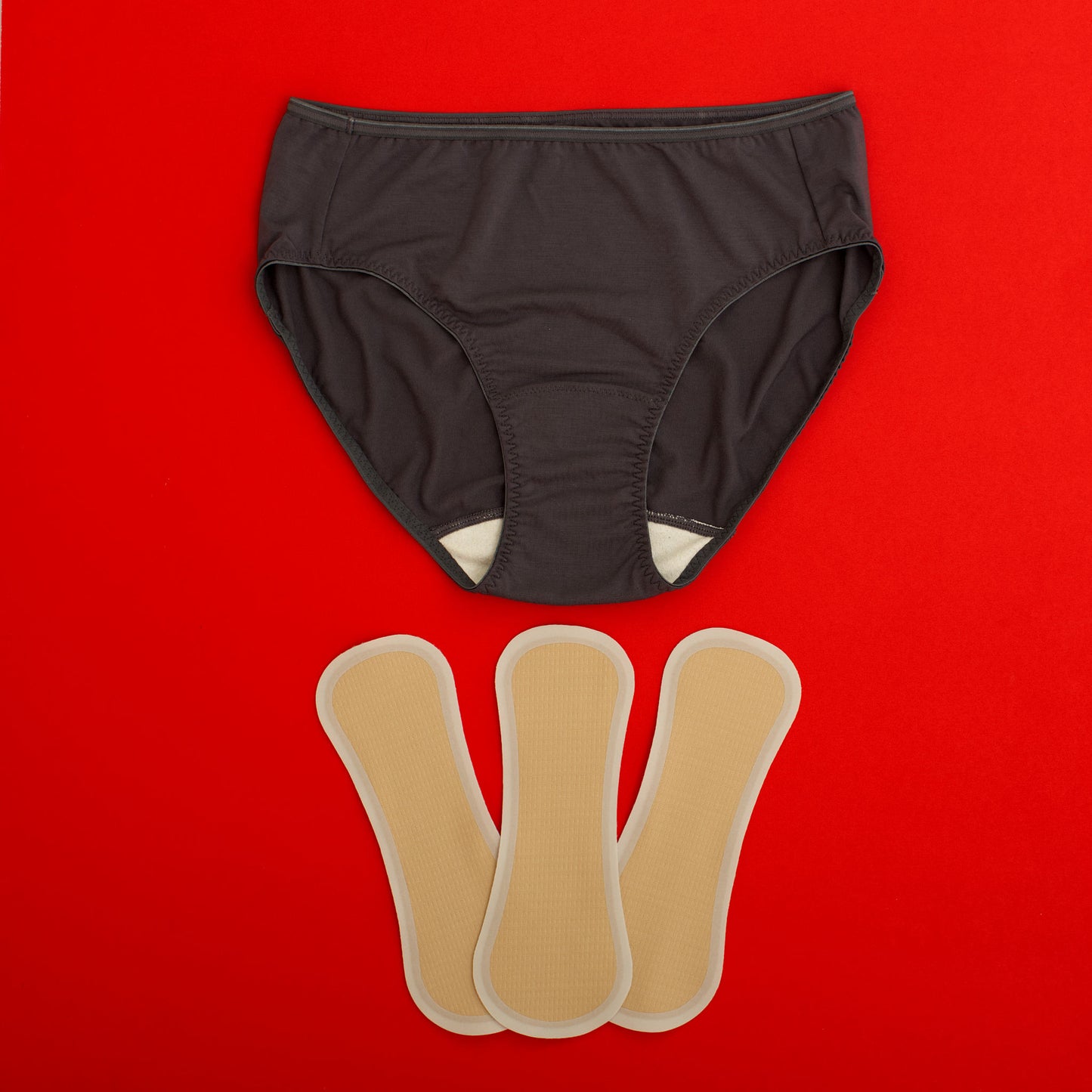 What is the Stay & Hold Set? A black breathable period panty paired with three adhesive-free liners designed for comfort, antimicrobial protection, and leakproof wear.