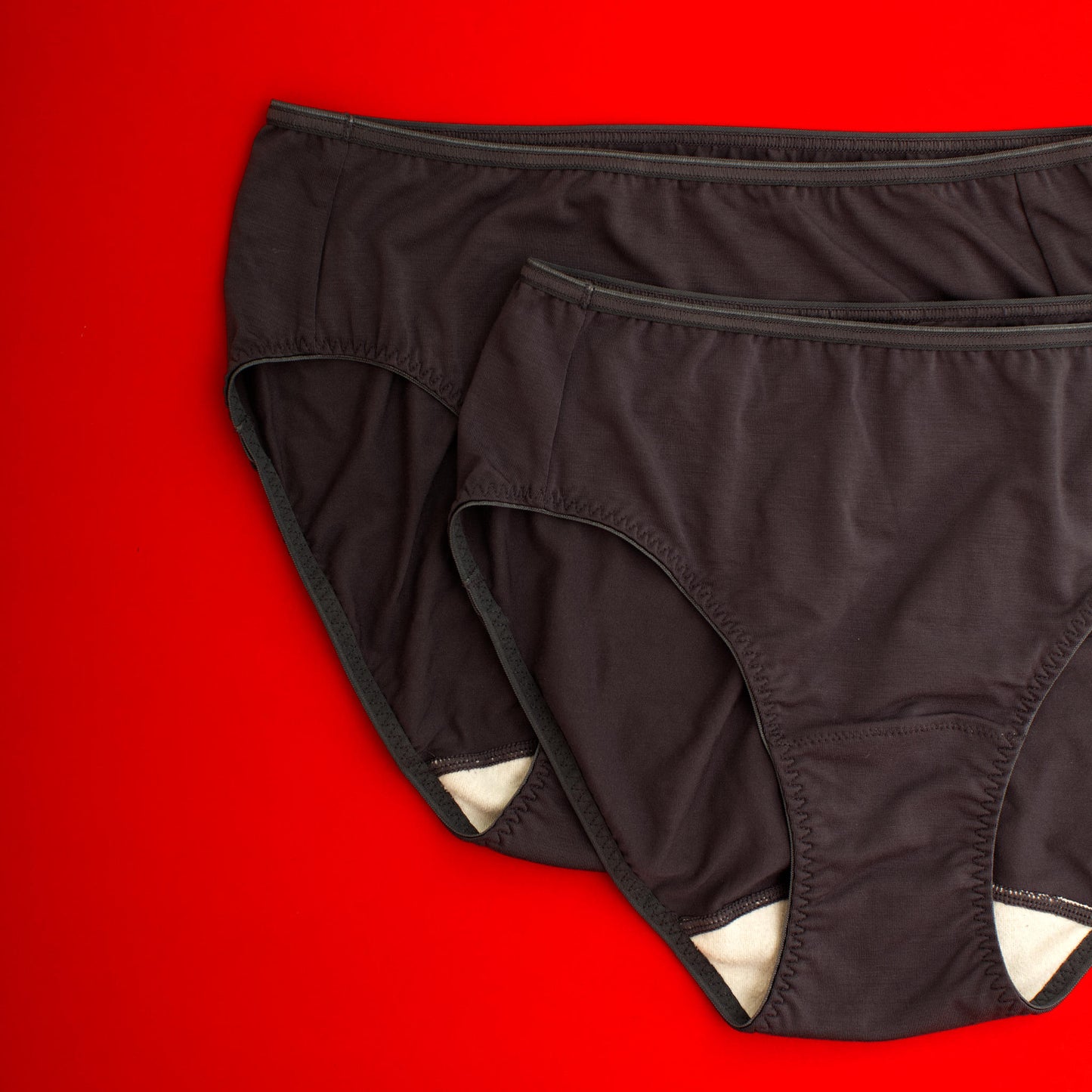 Black underwear with wide white gusset  on a red background