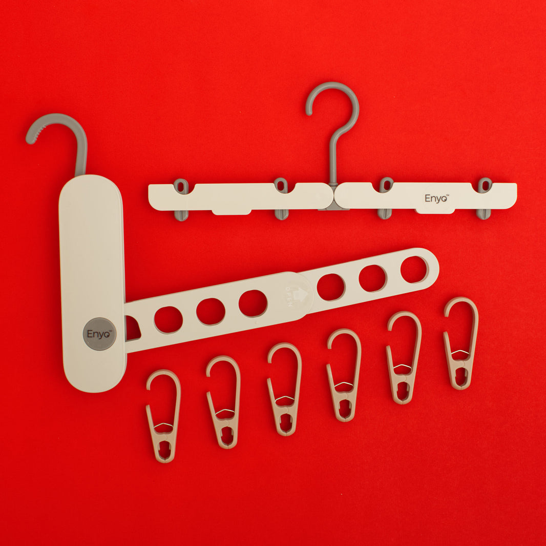 One white and grey foldable travel hanger with 4 clips, a foldable portable white and grey hanger rack with 7 holes and a hook, and six light brown hook clips clothing drying accessories for reusable menstrual care products