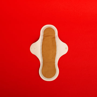 Reusable sanitary cloth pad with wings on a red background